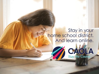 student writing and smiling