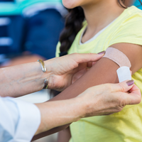 putting bandaid on child